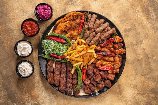 Assorted mix grills with tikka boti seekh kabab of chicken, beef, lamb, mutton bbq platter served in dish isolated on table top view of arabian food