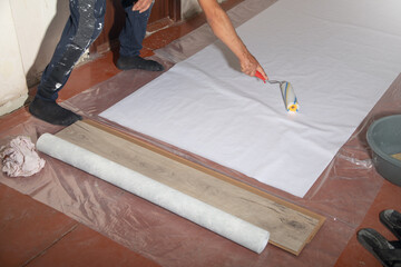 Caucasian worker prepare wallpaper in house renovation.