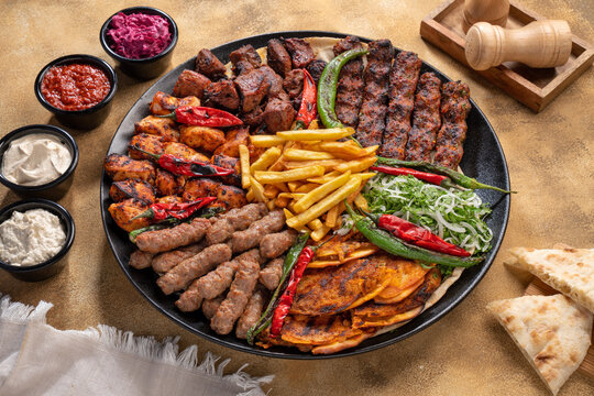 Assorted mix grills with tikka boti seekh kabab of chicken, beef, lamb, mutton bbq platter served in dish isolated on table top view of arabian food