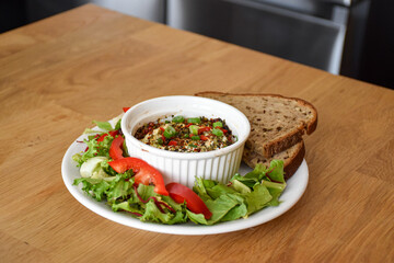 Snack in a white ceramic bowl with vegetables