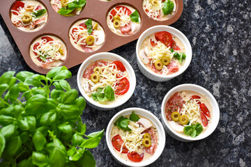 Pizza muffins with basil, olives, tomatoes