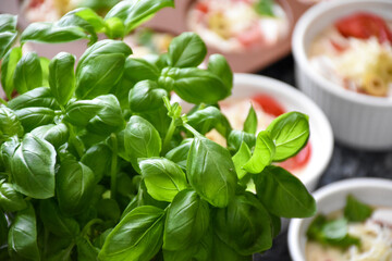 Pizza muffins with basil, olives, tomatoes