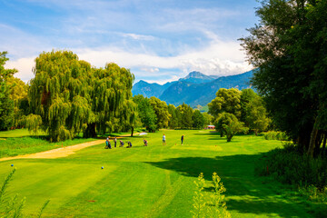 Golf Course with Mountain View and Clouds in a Sunny Summer Day in Granges, Valais, Switzerland.