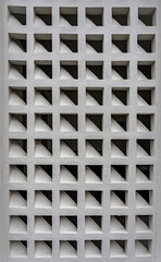 Perspective view of brick block vents on concrete wall in construction site for ventilation air.