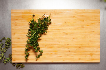 view from above of thyme and other herbs on a cutting board