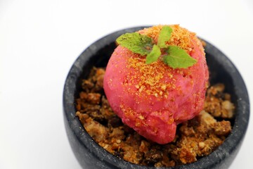 Close-up of a vibrant apple crumble with red fruit ice cream.