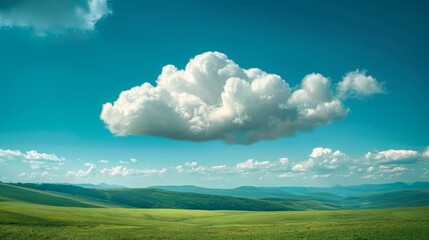 Obraz premium A fluffy white cloud floating in a vibrant blue sky above a green landscape.