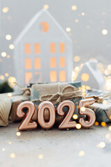 Christmas and New Year card. Number 2025 on holiday background. Christmas lights bokeh background. Holiday postcard. Happy New Year 2025 Card Concept.