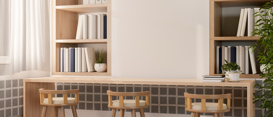 A long wooden table with stools against the wall with wall shelf in a minimalist Scandinavian room.