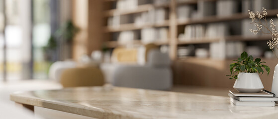 A close-up image of a neutral marble coffee table in a contemporary spacious living room.