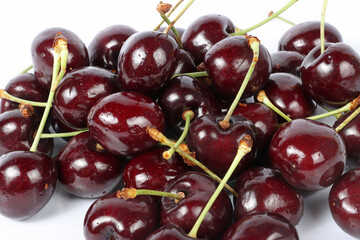 close up of cherries on white 