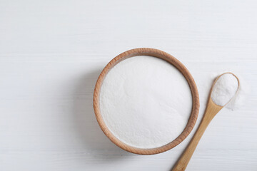 Baking soda on white wooden table, top view. Space for text