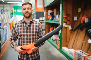 a young man in a gardening equipment store