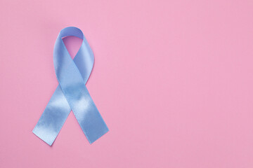 International Psoriasis Day. Ribbon as symbol of support on pink background, top view. Space for...
