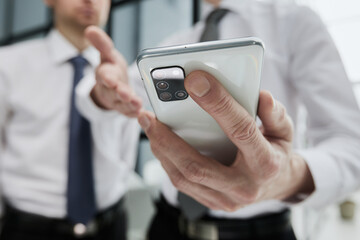 man using smartphone pressing finger, reading social media internet, typing text or shopping online.