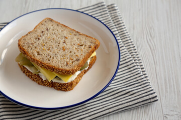 Homemade Pickle Sandwich with Mayo and Cheese on a Plate, side view. Copy space.