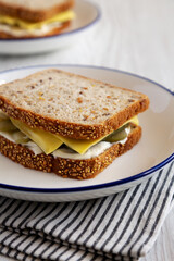 Homemade Pickle Sandwich with Mayo and Cheese on a Plate, side view. Close-up.