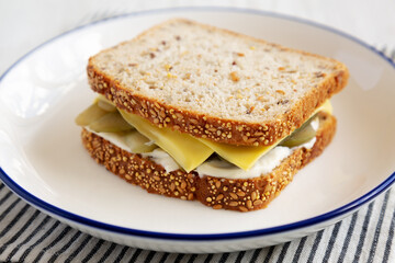 Homemade Pickle Sandwich with Mayo and Cheese on a Plate, side view. Close-up.