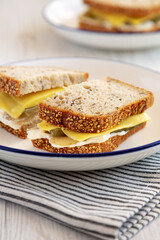 Homemade Pickle Sandwich with Mayo and Cheese on a Plate, side view.