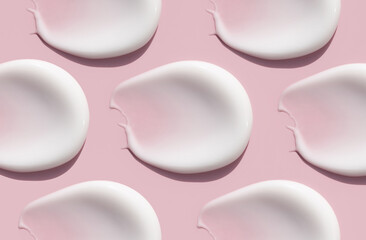 pattern cosmetic smears cream texture on a light pink background