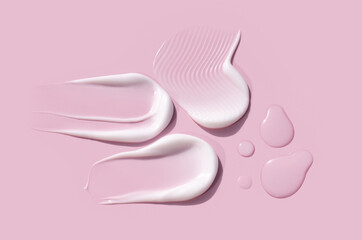 cosmetic smears cream texture on a light pink background