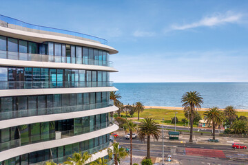 Fototapeta premium Drone view of a building with the ocean behind it in St Kilda, Melbourne, Australia. 