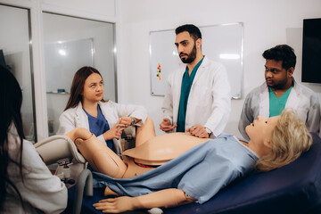 Gynaecologists learn to deliver babies on a mannequin