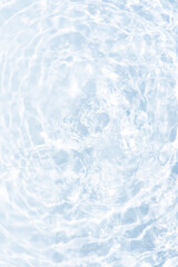 Blue water with ripples on the surface. Defocus blurred transparent blue colored clear calm water surface texture with splashes and bubbles. Water waves with shining pattern texture background.