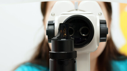 Close-up view of an ophthalmologist examining a patient's eye. The concept of modern medical...