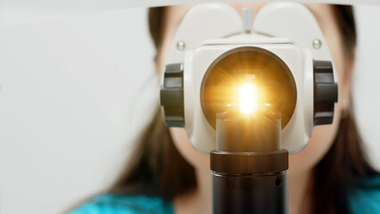 Close-up view of an ophthalmologist examining a patient's eye. The concept of modern medical...