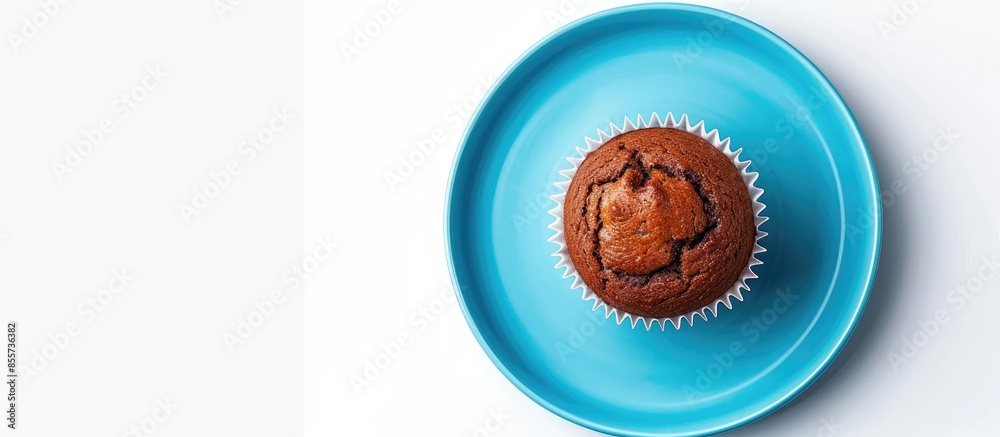 Poster organic homemade vanilla chocolate butter cup cake muffin bread is on the blue plate and isolated on white background (clipping path included). with copy space image. Place for adding text or design