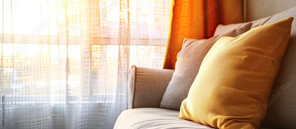 Poster Comfortable pillow on modern sofa next to window with soft light effect. with copy space image. Place for adding text or design