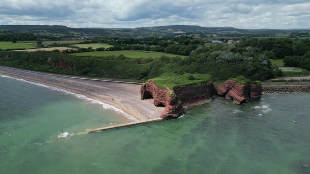 Dawlish Warren, River Exe, South Devon, England: DRONE VIEWS: Langstone Rock and Dawlish Warren funfair including a ferris wheel. South Devon is a popular UK holiday destination (Clip 2).