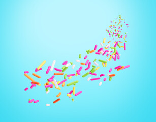 Colorful Sprinkles Or Meises For Cakes Flowing Coming In The Air on cyan Background 3D Illustration
