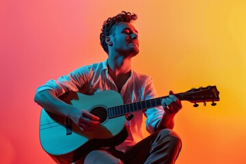 Obraz premium Portrait of a blissful man in his 30s playing the guitar in solid color backdrop