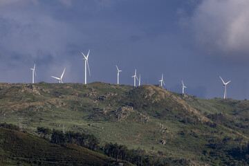 Silhouettes of wind turbines, wind power plants in Portugal, Europe. Ecological, saving energy