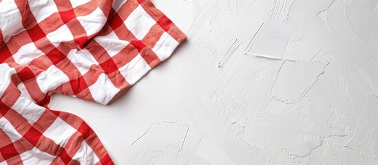 Fototapeta premium Red and white fabric tablecloth checkered on white background with copy space. Copy space image. Place for adding text or design