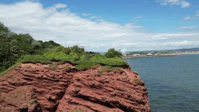 Dawlish Warren, River Exe, South Devon, England: DRONE VIEWS: The coastline, railway track, the River Exe estuary and a funfair with ferris wheel. South Devon is a popular UK holiday resort (Clip 2).