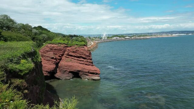 Dawlish Warren, River Exe, South Devon, England: DRONE VIEWS: The coastline, railway track, the River Exe estuary and a funfair with ferris wheel. South Devon is a popular UK holiday resort (Clip 1).