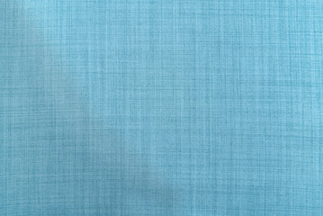 The texture of the fabric is light blue. Linen material. Textile