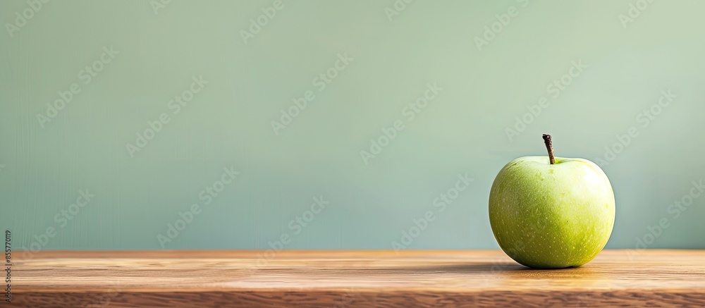 Aufkleber green apple on wooden table in the living room. with copy space image. place for adding text or desi