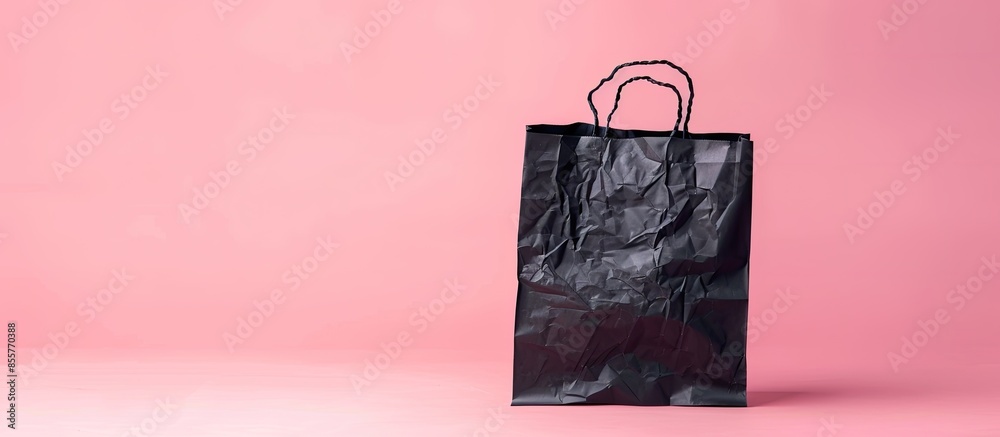 Poster black crumpled shopping paper bag pastel background. with copy space image. place for adding text or
