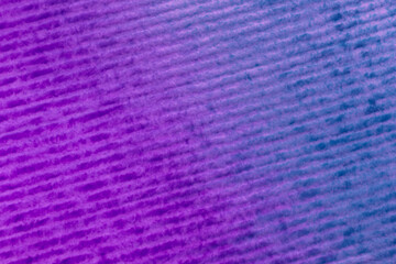 close up of striped paper stained with purple and blue colors