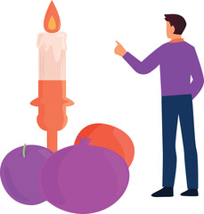 The boy is pointing at the candle.