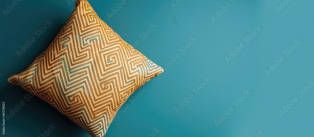 Aufkleber Decorative pillow with brown geometric pattern isolated on a blue background . with copy space image. Place for adding text or design