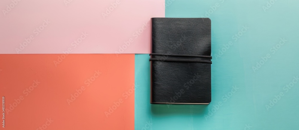 Poster Black leather notebook isolated on a pastel background. with copy space image. Place for adding text or design