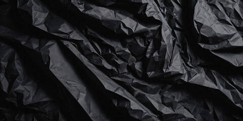 Obraz premium Black crumpled paper texture. Crumpled black paper abstract shape background with space paper for text perfect for adding depth and character to your designs, creative projects, backgrounds