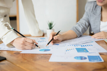 Business women meeting discussion over charts and graphs in a conference room at the office