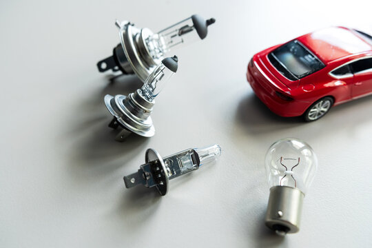 different automotive bulbs h1 h4 h7 with small toy car. Car repair conecpt