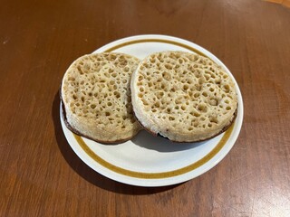 Crumpets (small griddle breads made from an unsweetened batter of water or milk, flour, and yeast)